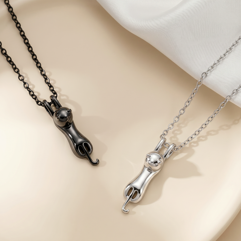 Personalized cat urn necklace pair in rhodium and black, cat-shaped sculptural pendants with engraved belly panels