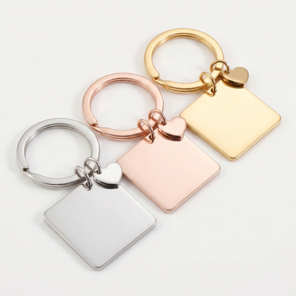 Pet portrait square keychain in three finishes — rhodium silver, 18k gold, 18k rose gold — each with a dangling heart charm