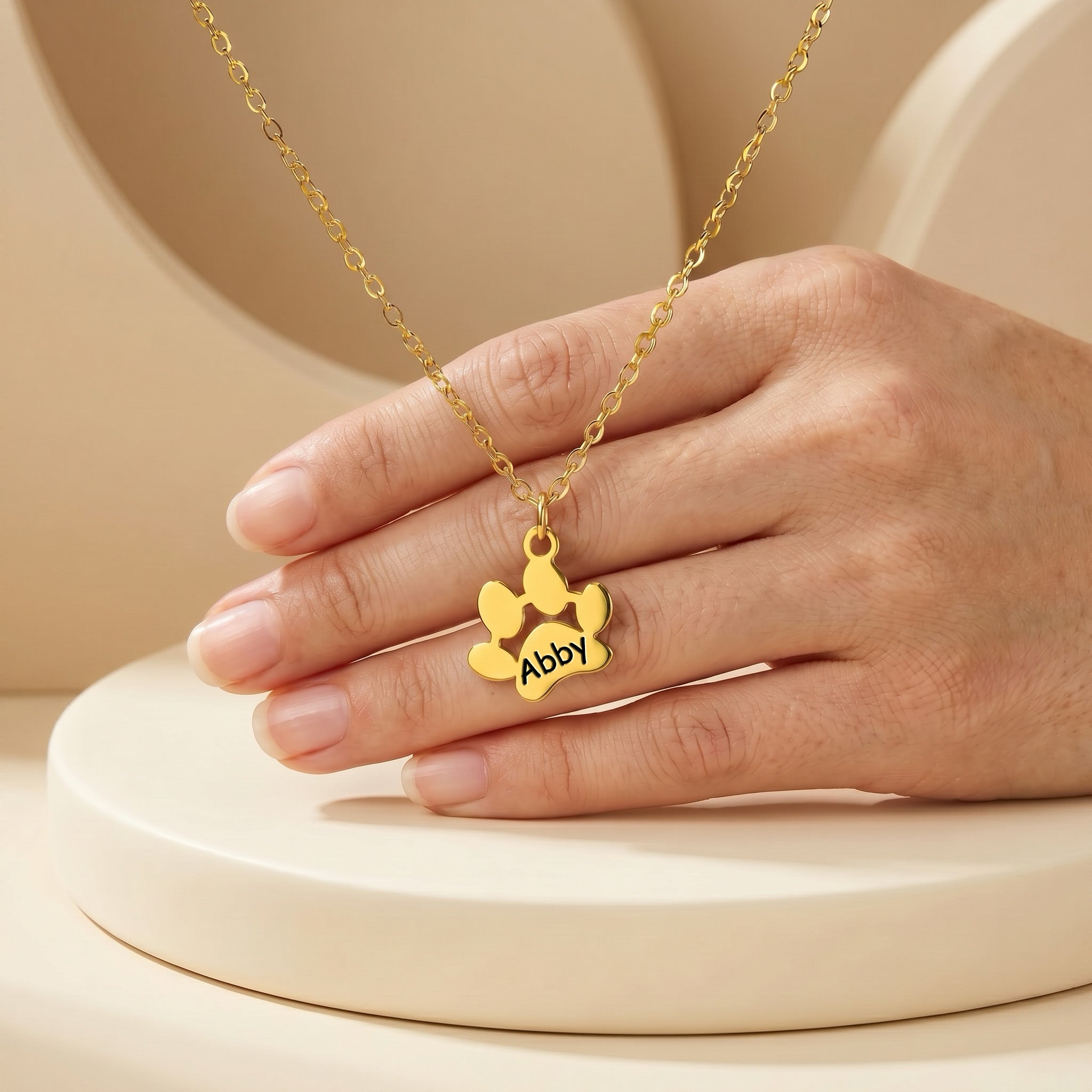 Gold paw print name necklace with single engraved paw pendant on cable chain