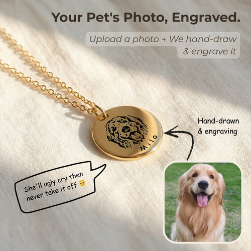 Gold pet face necklace with hand-drawn dog portrait engraving on disc pendant, shown on fabric