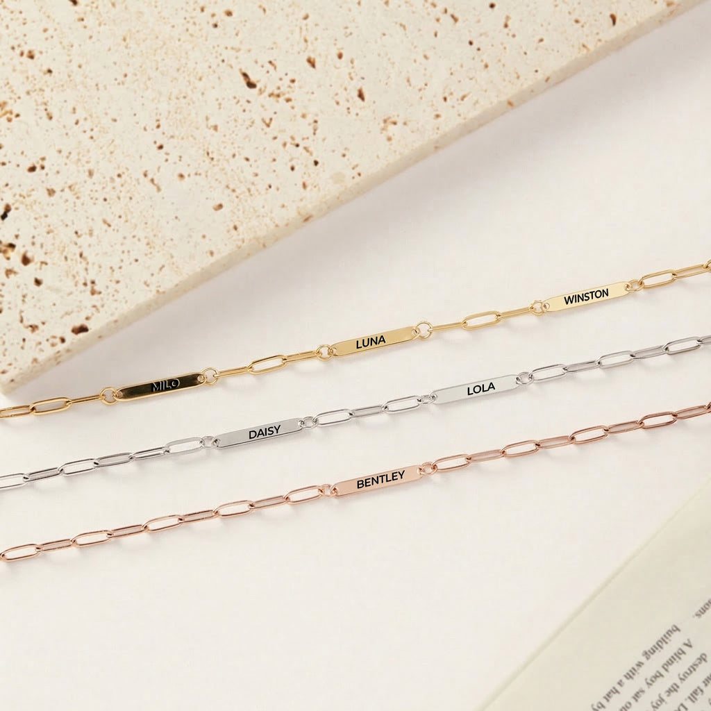 Three multiple pet name necklaces side by side in gold, silver, and rose gold paperclip chains with engraved name bars
