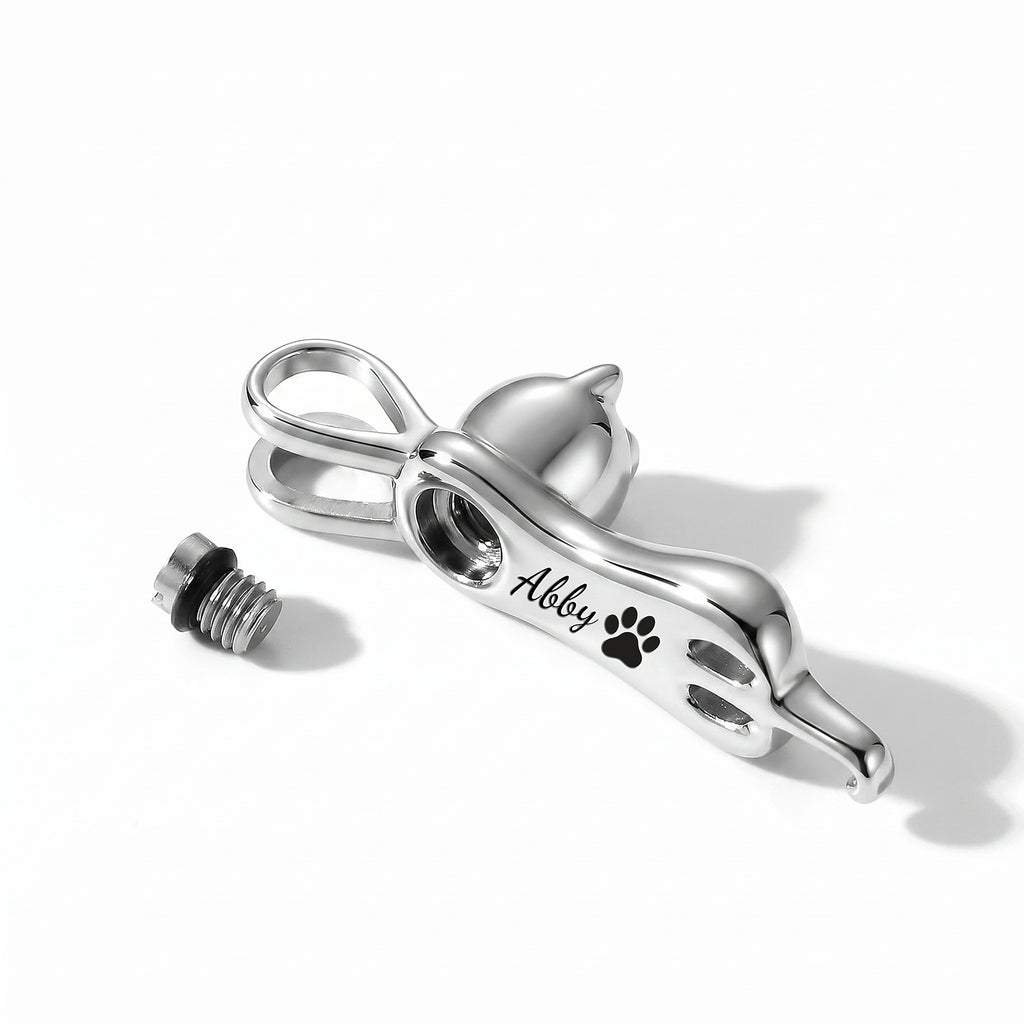 Cat urn necklace shown with screw cap removed revealing internal urn cavity opening for cat ashes