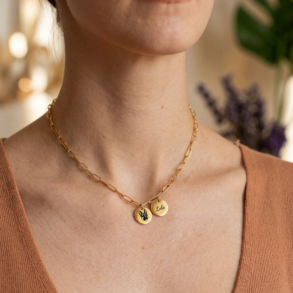 Woman wearing gold paperclip chain pet portrait necklace over knit sweater, close-up