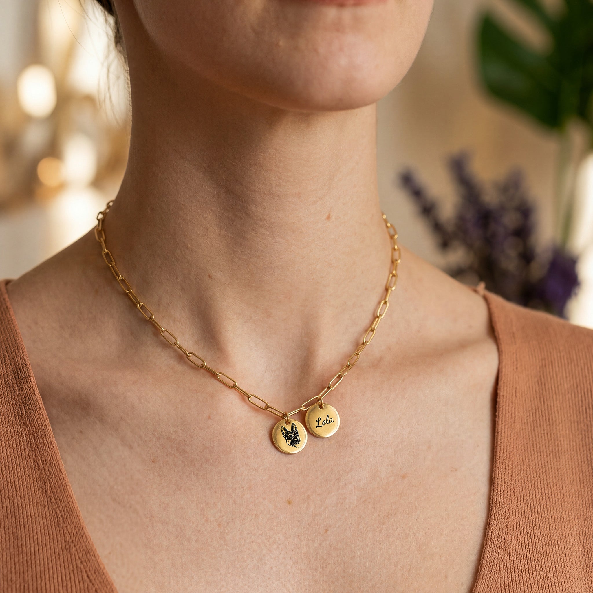 Woman wearing gold paperclip chain pet portrait necklace over knit sweater, close-up