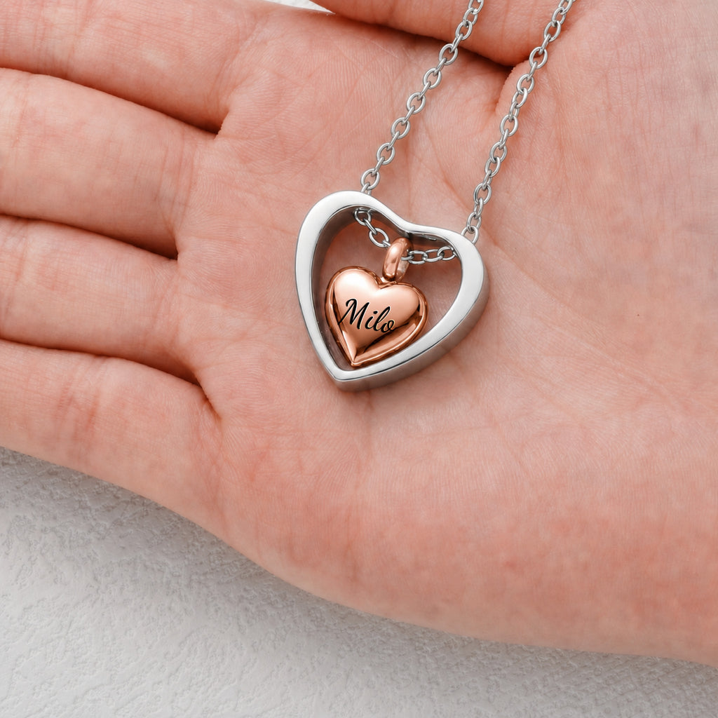 Rose gold heart urn cremation pendant shown in hand for size reference, 20mm open heart frame