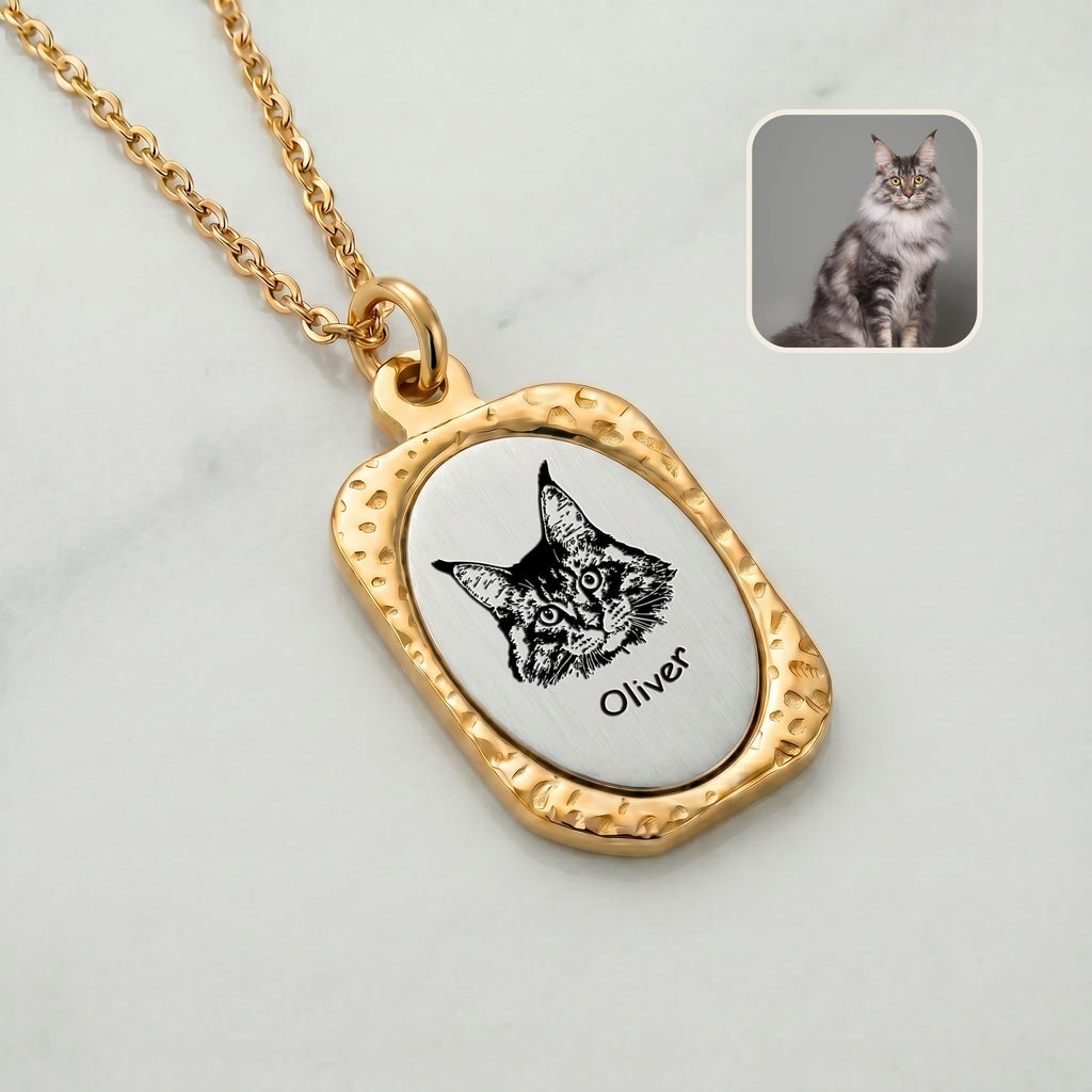 Close-up of 18K gold vintage tag pendant with hand-drawn cat portrait and name showing hammered frame detail