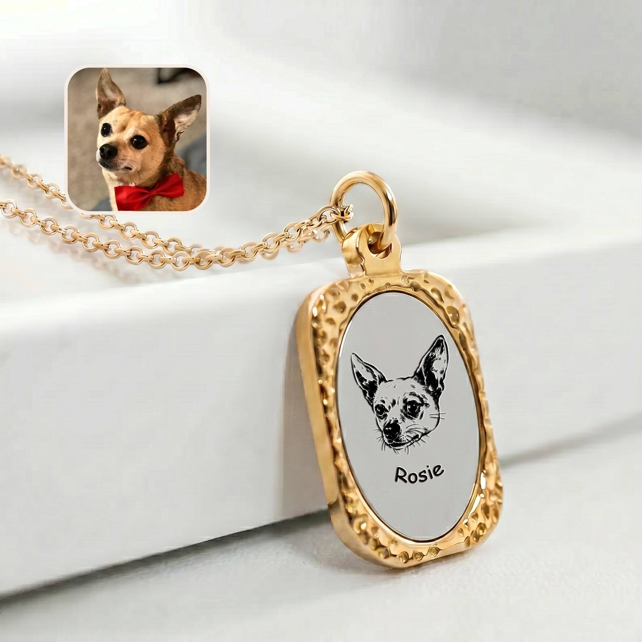 18K gold engraved pet necklace with hand-drawn chihuahua portrait draped on white surface, lifestyle detail