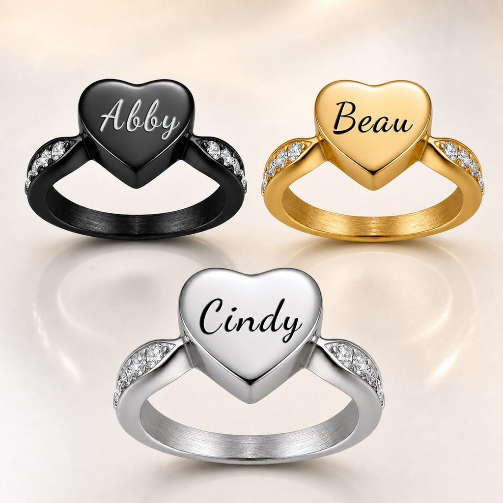 All three heart urn ring finishes side by side: black, gold, and silver, each with a different pet name engraved