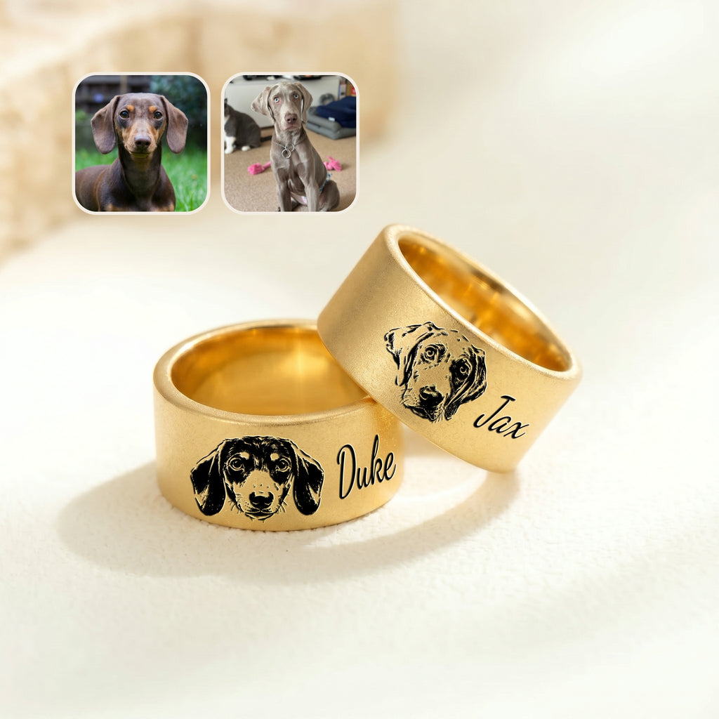 Two gold wide band pet rings on cream fabric, each engraved with a hand-drawn dog portrait and a script name, beside reference photos