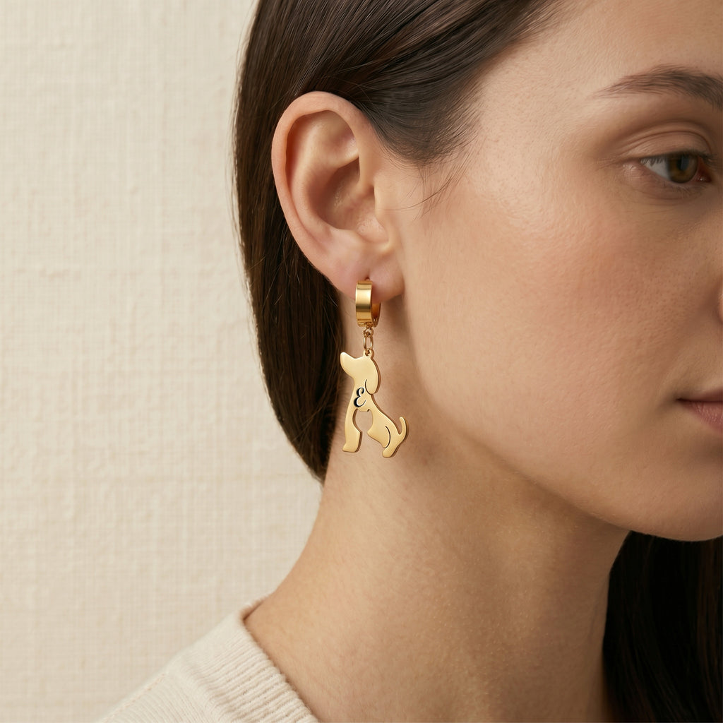 Model wearing a single gold dog-silhouette name earring