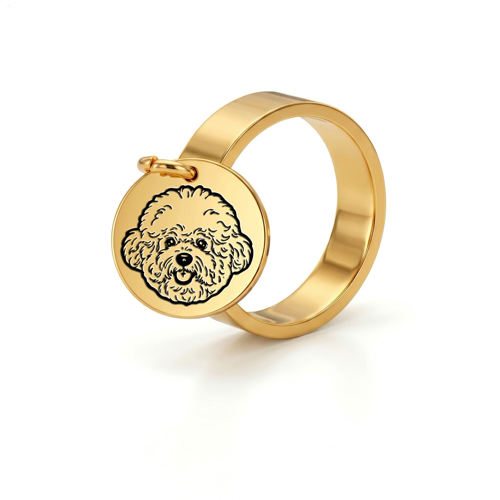 Yellow-gold wide-band ring with a small dangling pet-portrait disc charm, on a plain white background