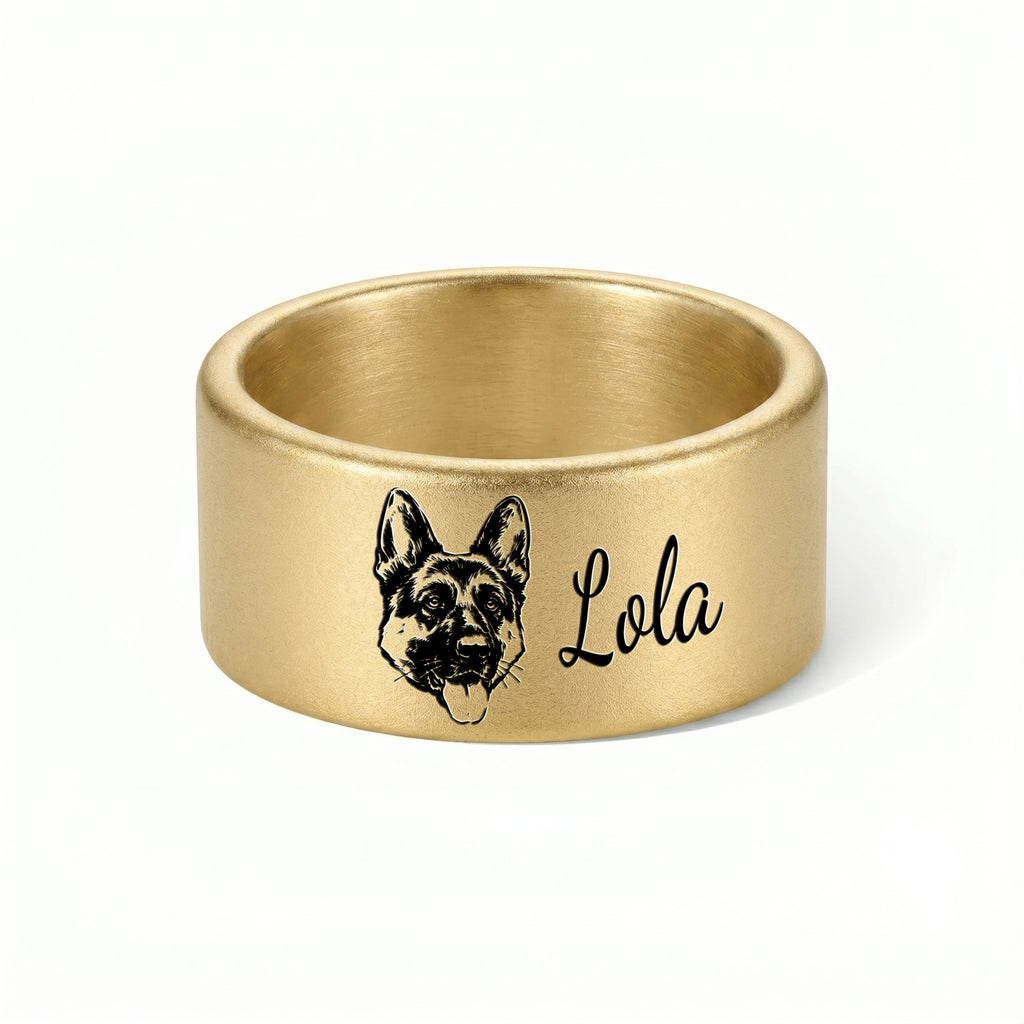Single gold wide band pet ring on a near-white background, engraved hand-drawn portrait and script name