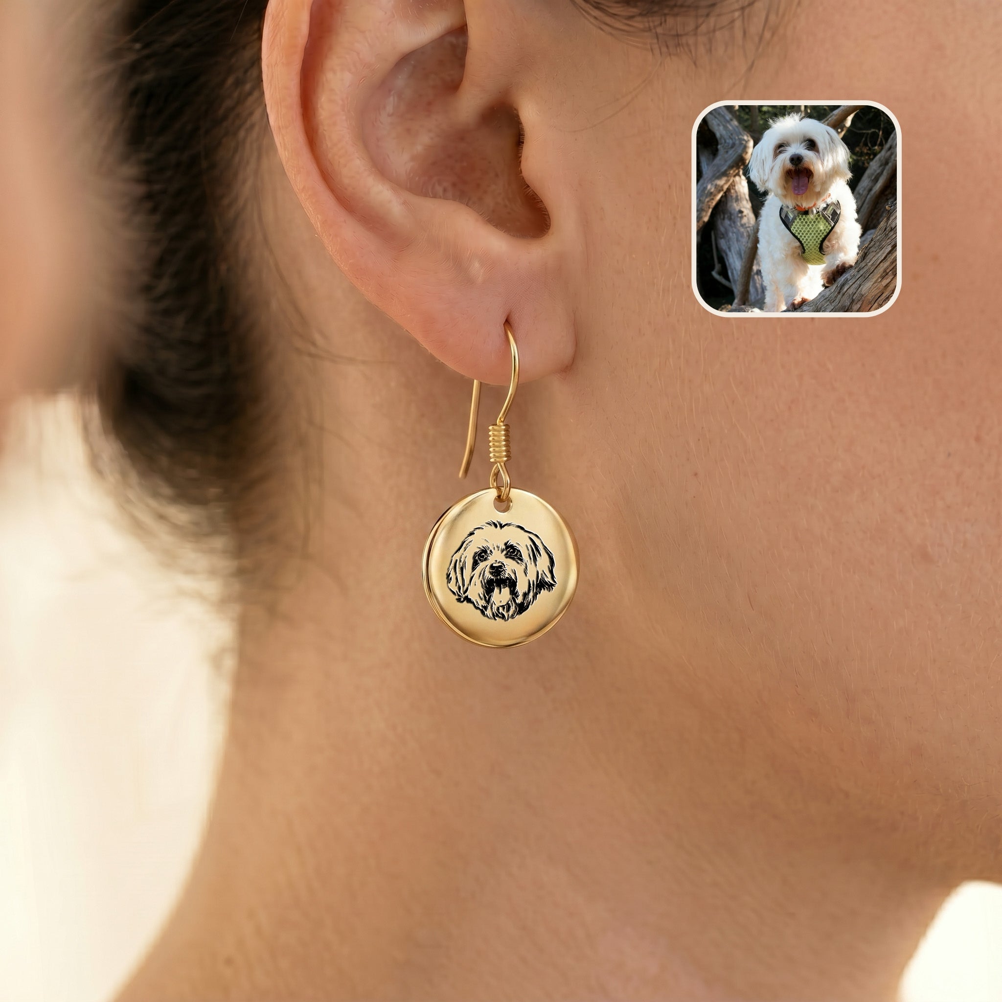Single gold portrait drop earring worn on one ear, with an inset photo of the white dog it was drawn from