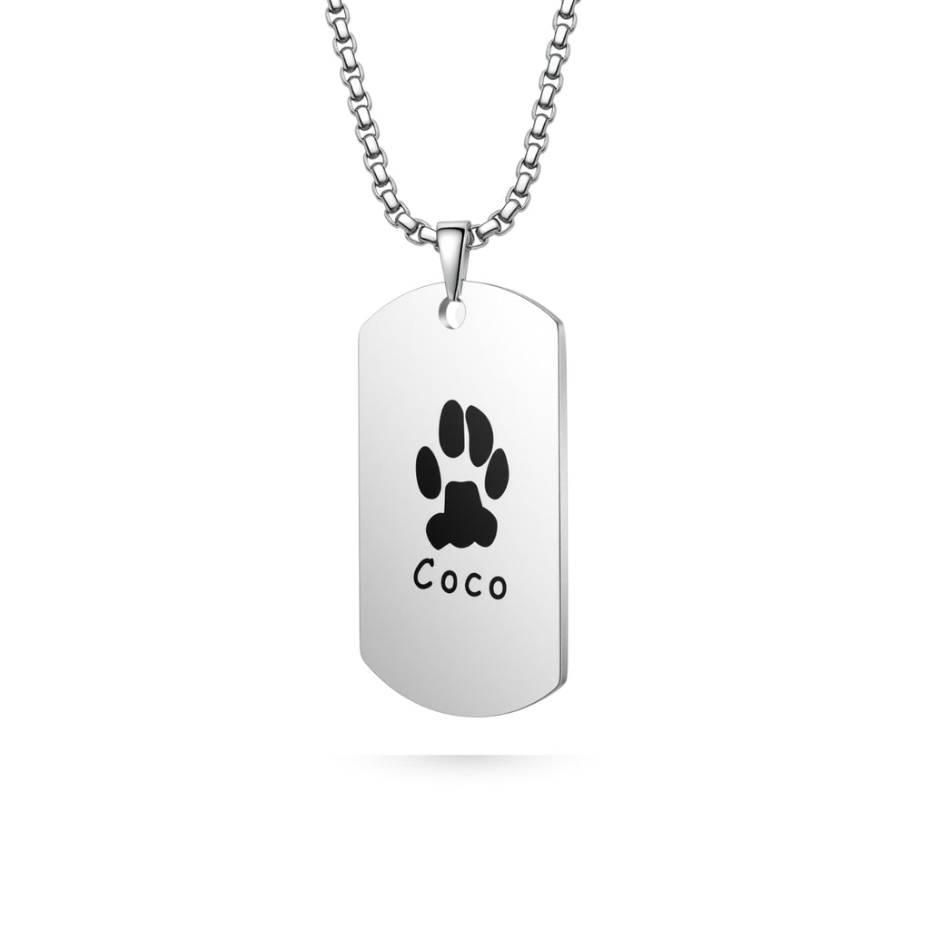 Silver dog tag shaped pendant necklace with laser-engraved paw print on white background