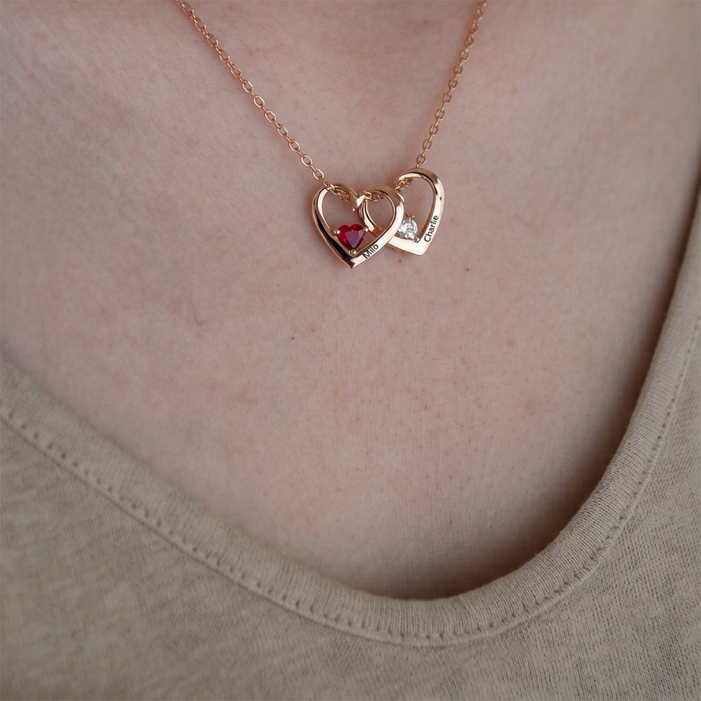18K rose gold heart birthstone necklace worn, two hearts with engraved pet names and birthstones