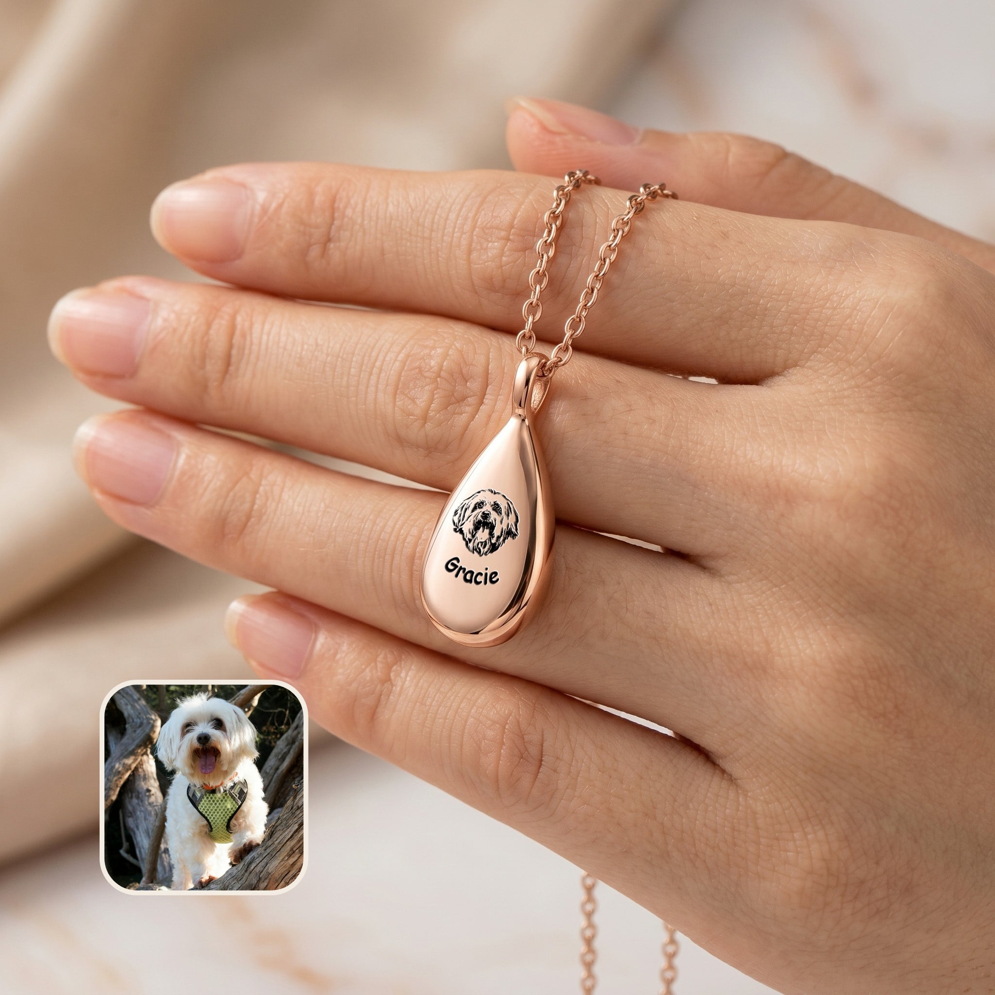 Rose gold teardrop pet photo urn necklace with hand-drawn portrait and name, held in hand