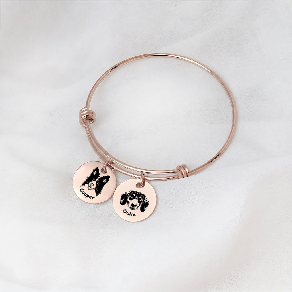 18K rose gold personalized pet bracelet with two engraved portrait disc charms on white fabric