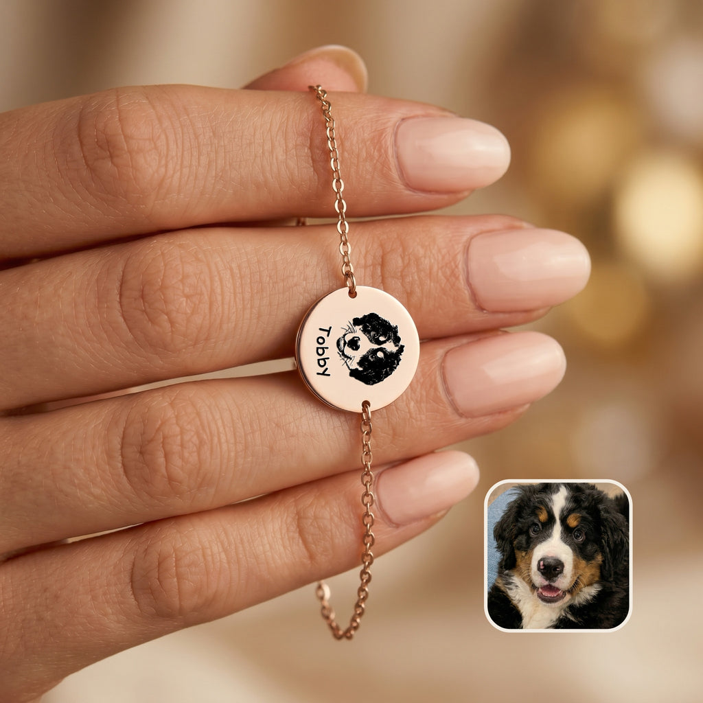 Rose gold chain bracelet held in hand showing hand-drawn dog portrait and name on disc charm, with inset Bernese Mountain Dog photo