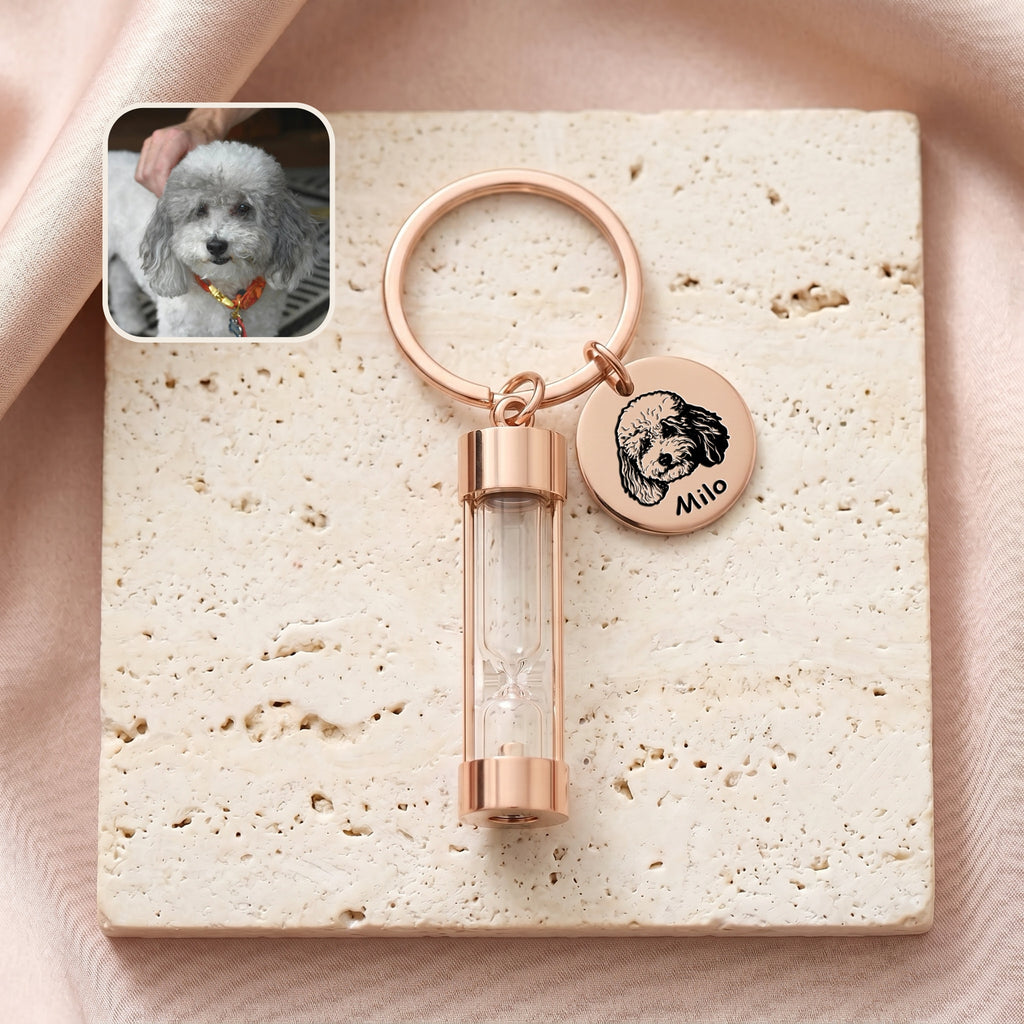 18k rose gold-plated pet portrait hourglass keychain on travertine stone with engraved poodle portrait disc and glass hourglass urn, with reference photo inset