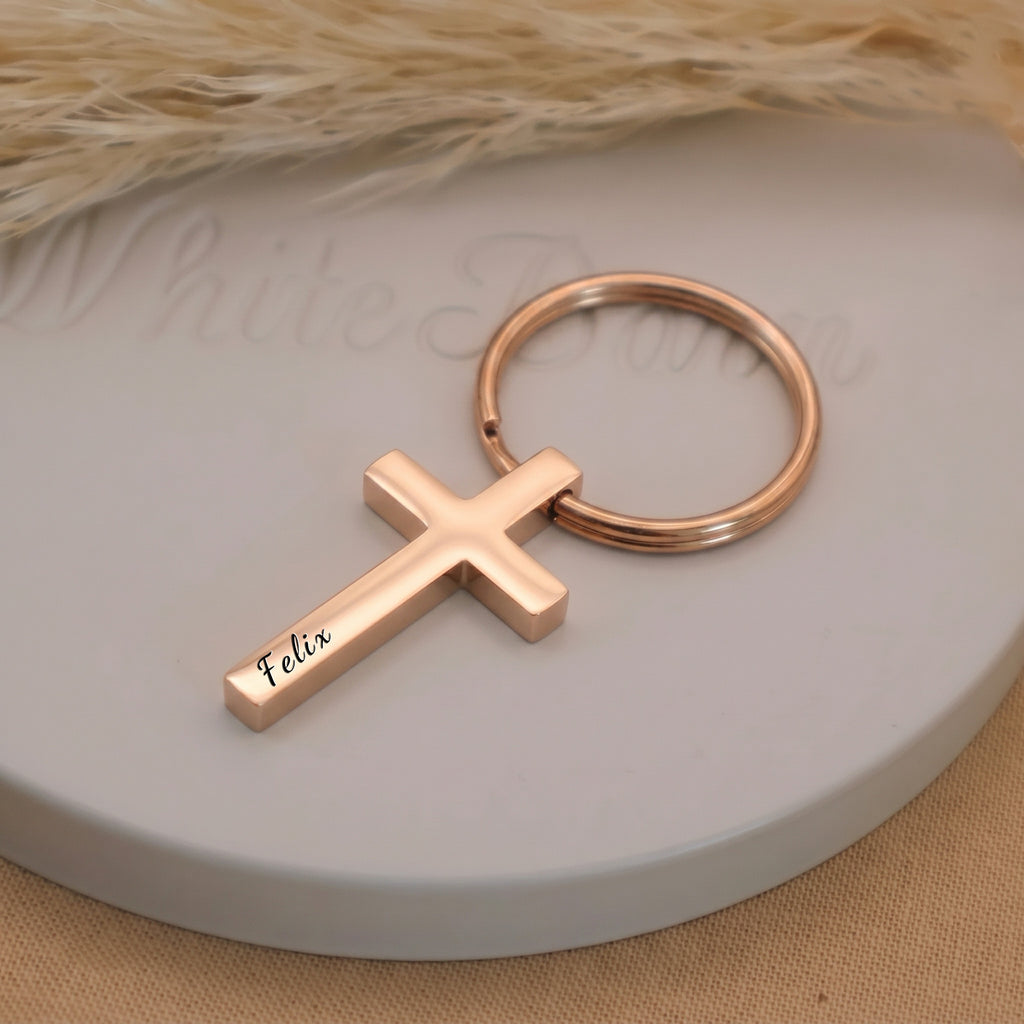 18k rose gold pet cross keychain single close-up on a ceramic tray — engraving detail of the hand-drawn portrait and script name on the front face