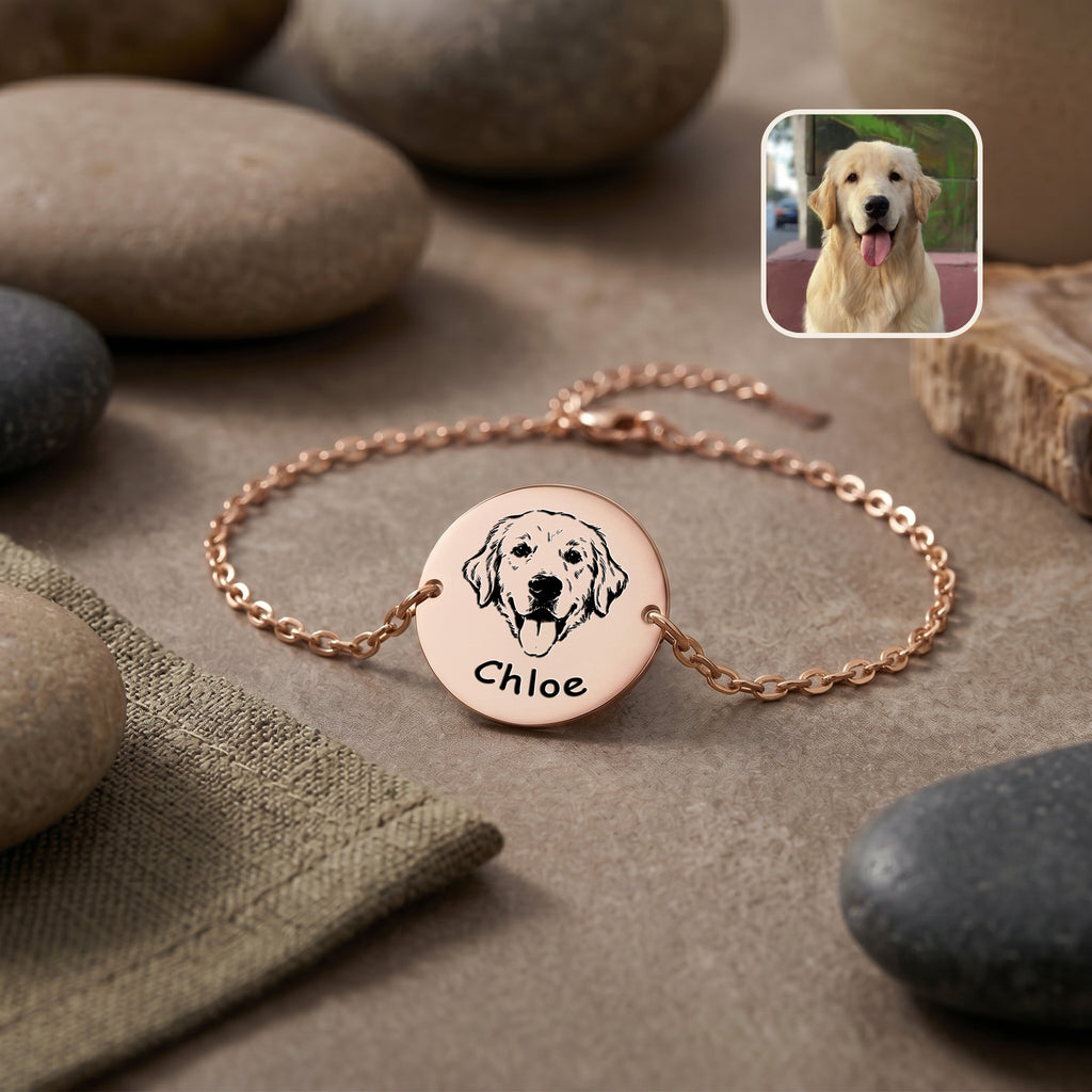 Rose gold pet portrait chain bracelet flat lay on stone surface, hand-drawn golden retriever portrait on disc, with inset pet photo