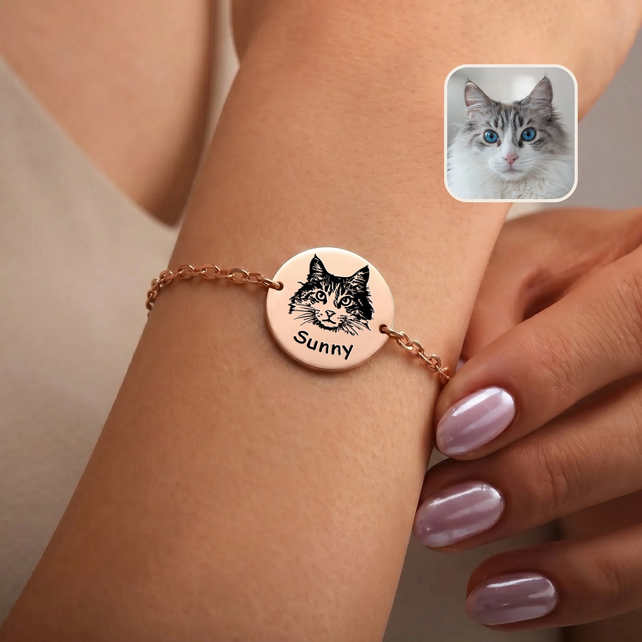 Rose gold pet portrait chain bracelet on a wrist, hand-drawn cat portrait and name on disc charm, with inset grey cat photo