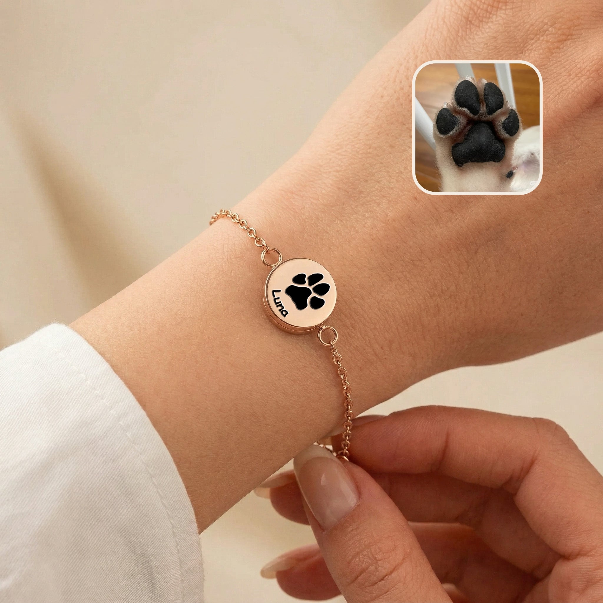 Rose gold pet locket bracelet worn on a wrist, the disc engraved with a pet name