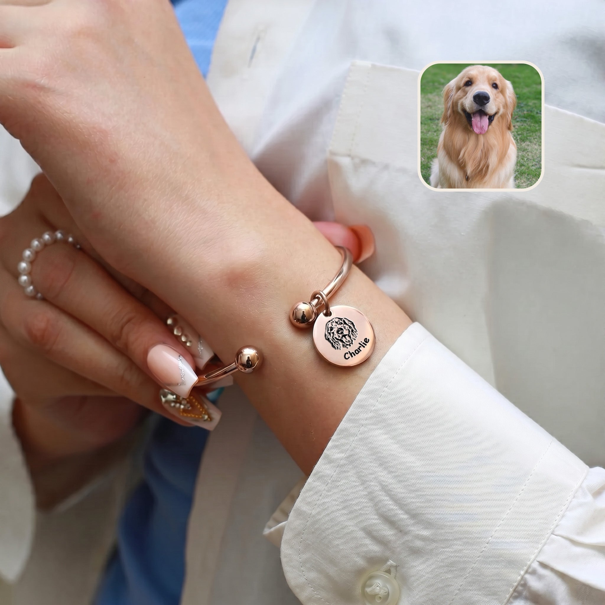 Rose gold pet photo bracelet worn over a white sleeve, with an inset golden retriever photo