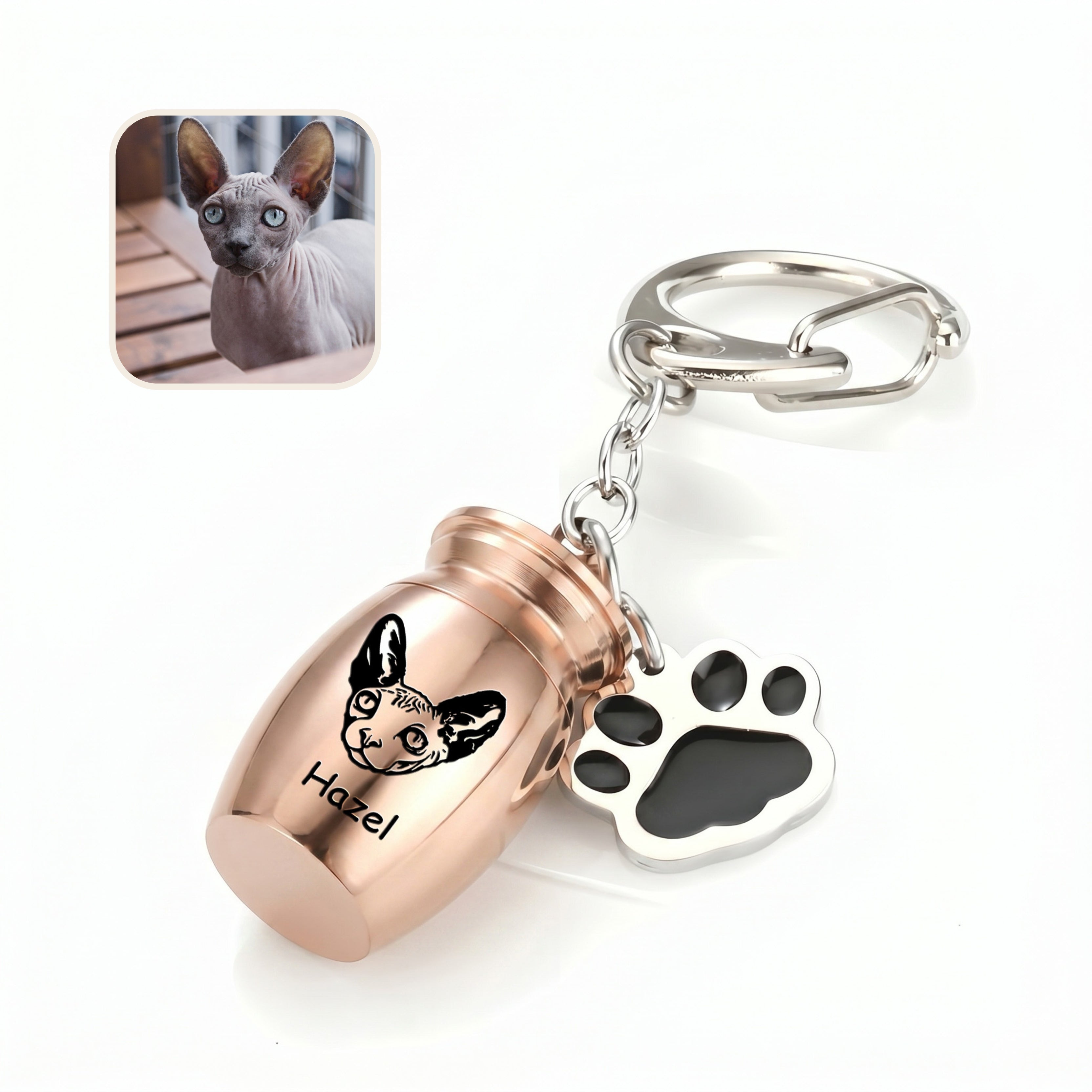 Angled 18k rose gold pet urn keychain close-up on a clean white surface with a cat reference photo inset, showing the hand-drawn portrait engraving on the capsule face