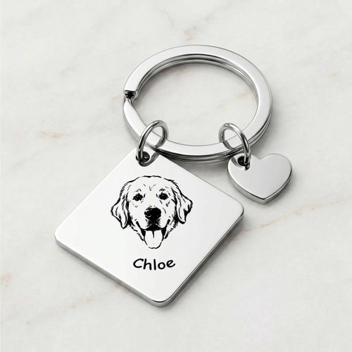 Rhodium pet portrait square keychain on marble surface with hand-drawn portrait and pet name engraved on the front
