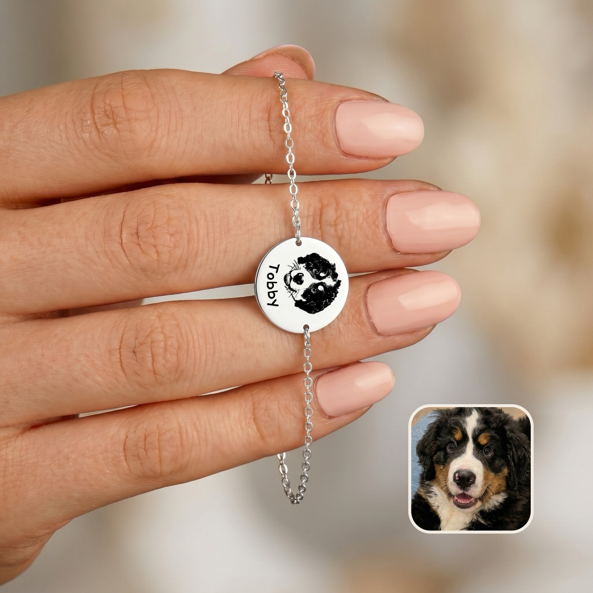 Rhodium chain bracelet held in hand showing hand-drawn dog portrait and name on disc charm, with inset Bernese Mountain Dog photo