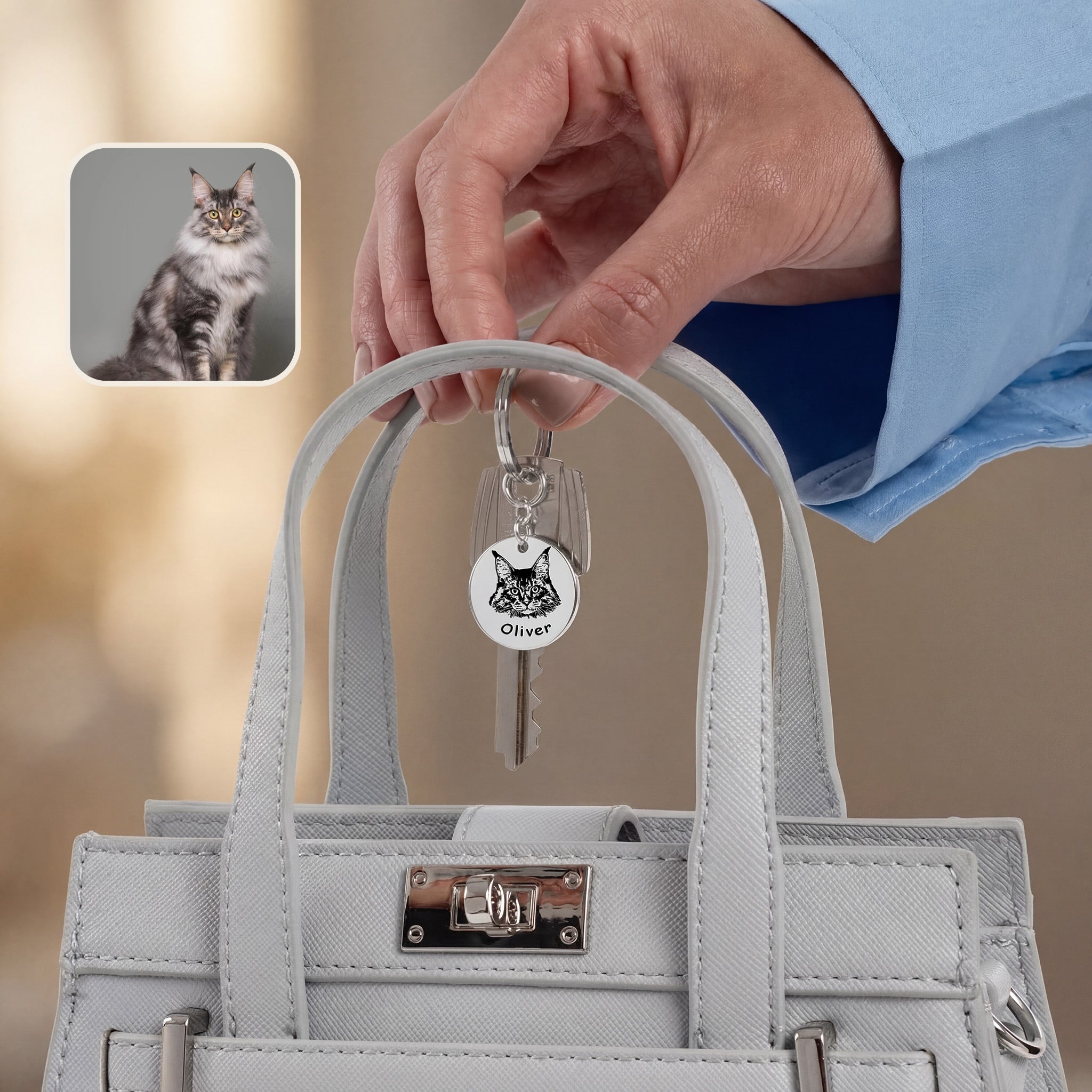 Rhodium pet face keychain clipped to keys — daily-carry lifestyle shot