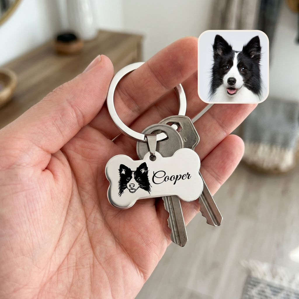 Rhodium pet bone keychain held in hand with keys — showing scale of the 31x16mm bone pendant for daily carry
