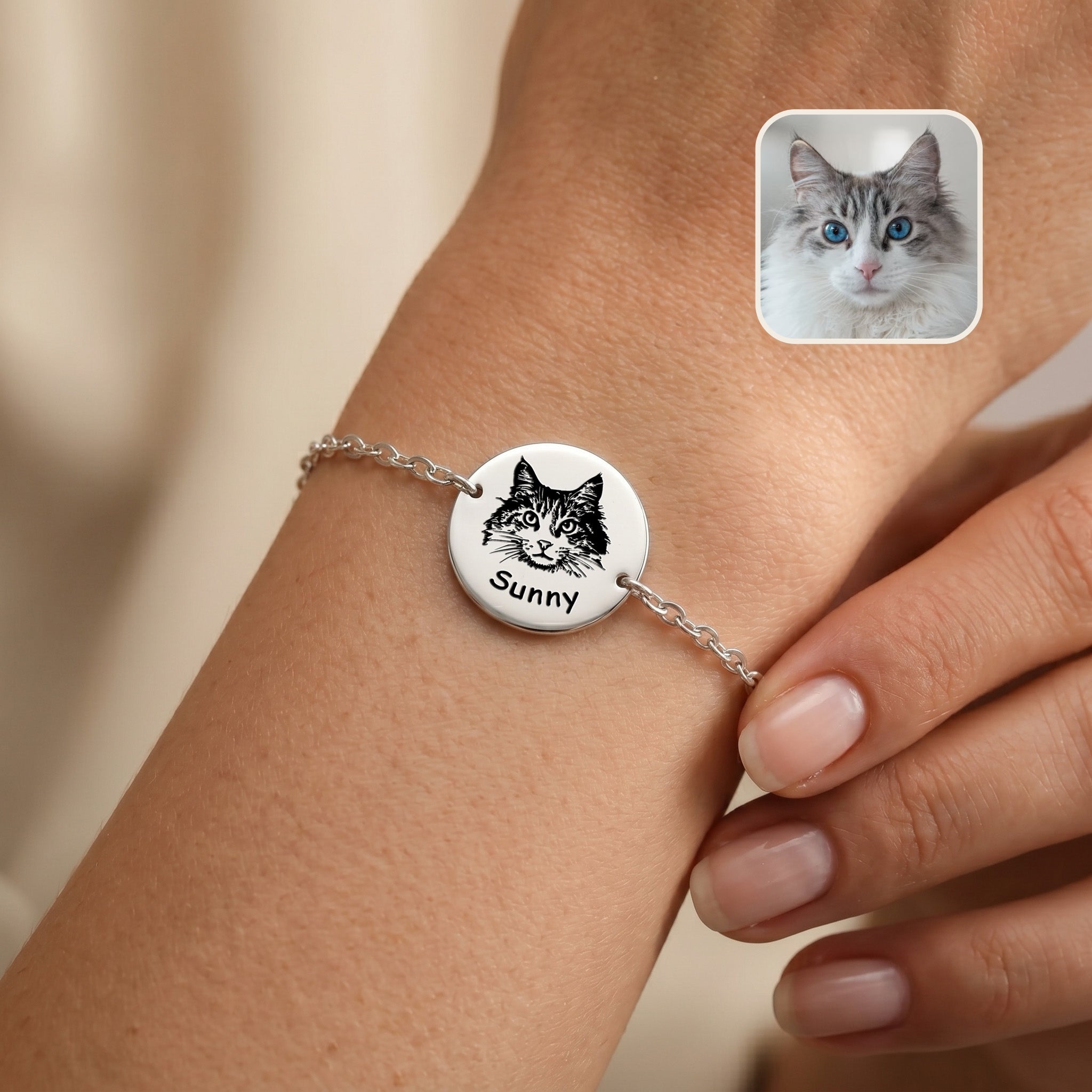 Rhodium pet portrait chain bracelet on a wrist, hand-drawn cat portrait and name on disc charm, with inset grey cat photo