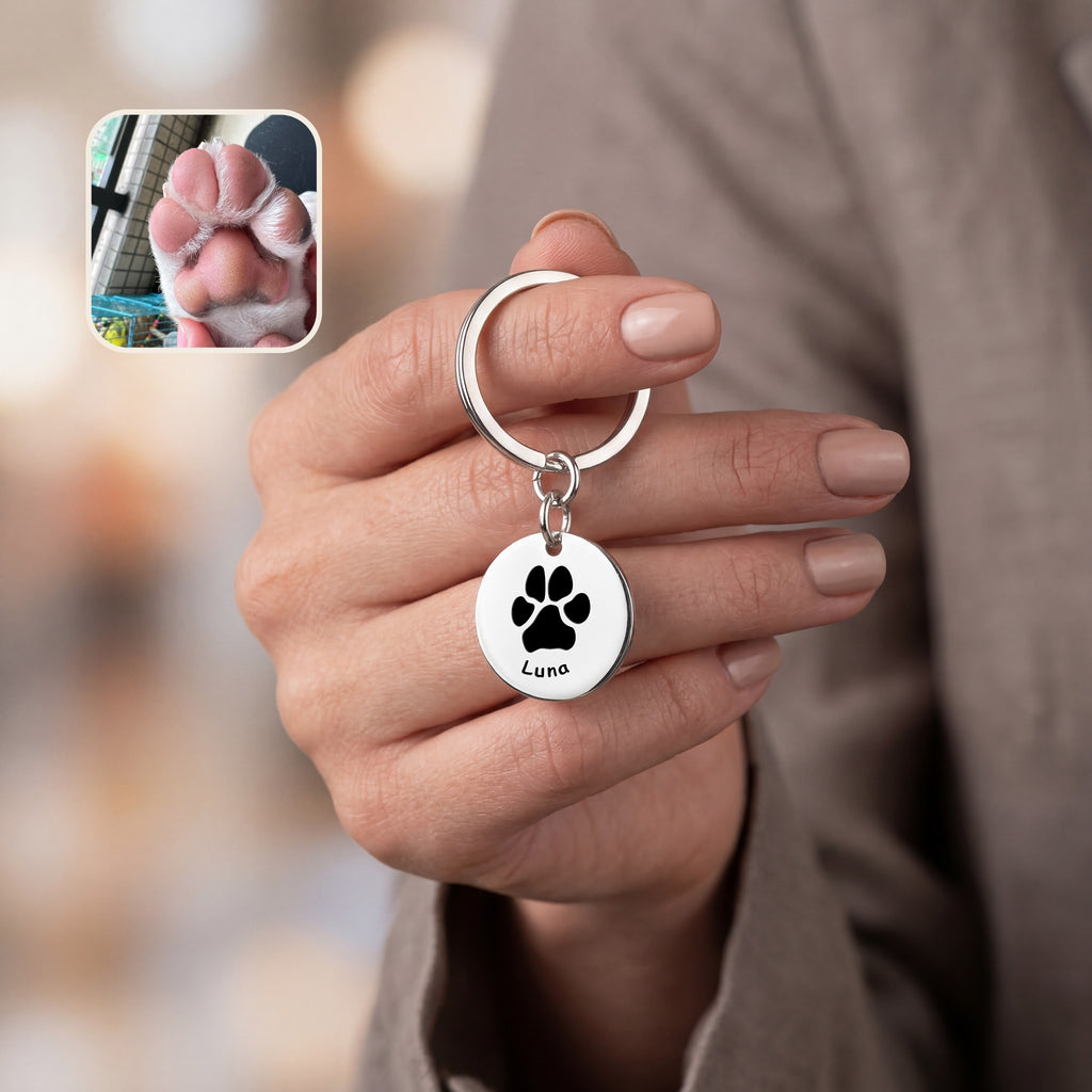 Rhodium pet keychain disc with an engraved paw print and the pet name Luna in script, pet paw photo reference inset