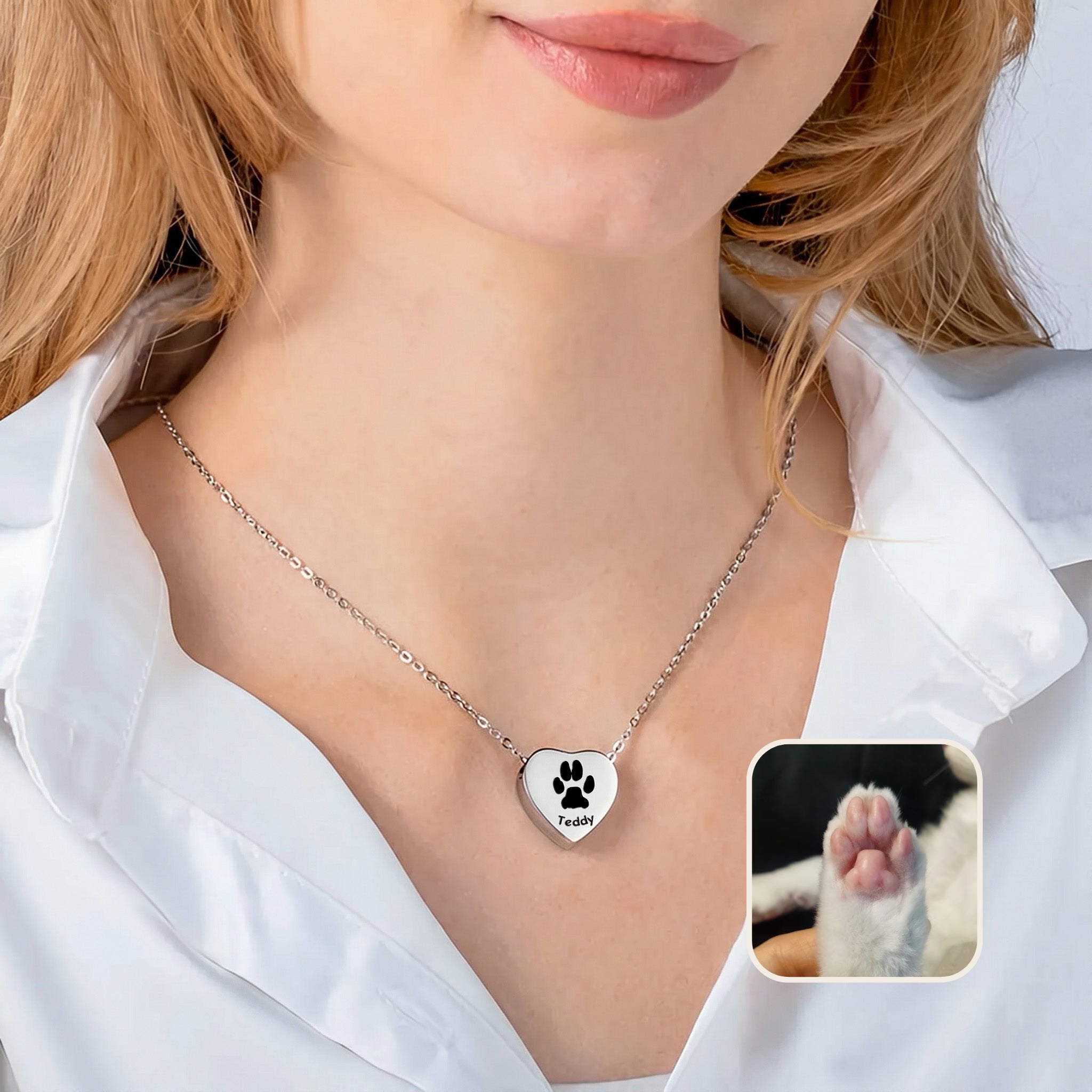 Woman wearing rhodium heart urn necklace with paw print engraving and pet photo reference inset