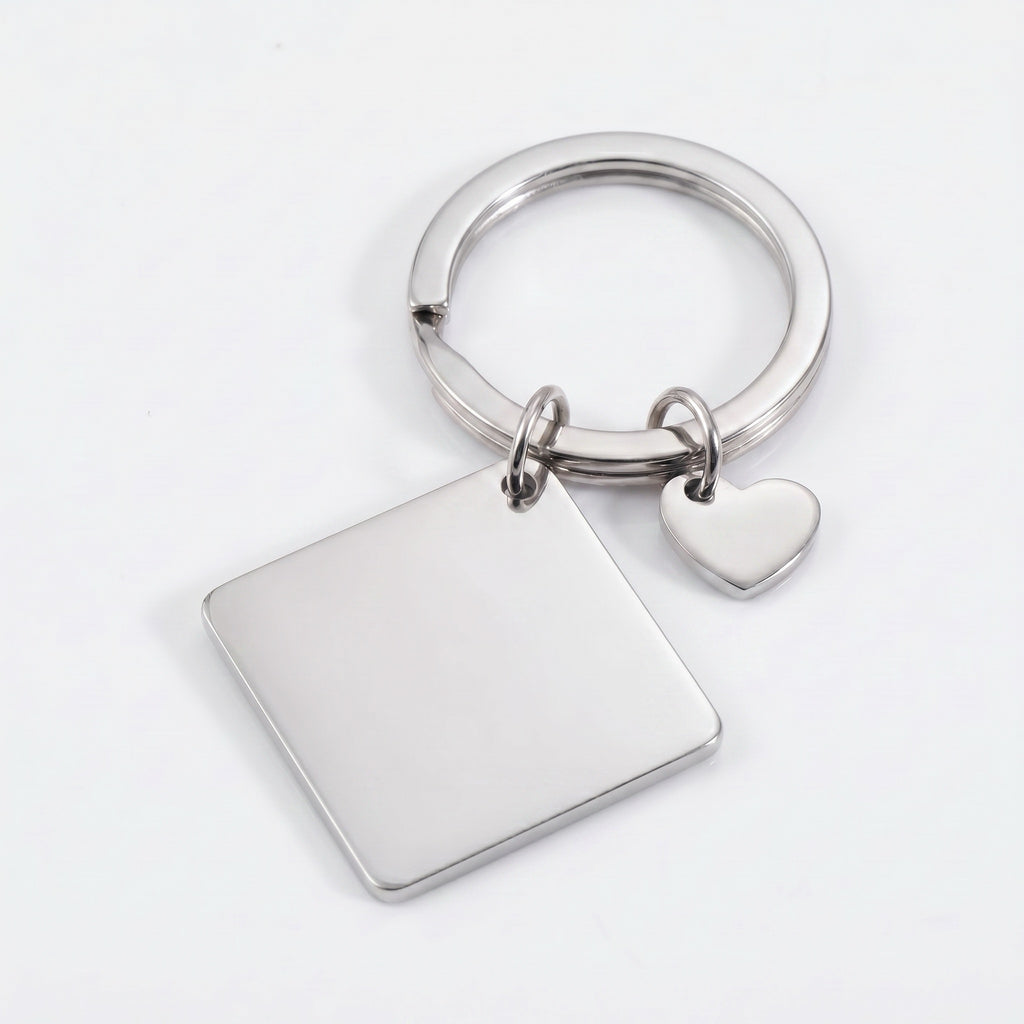 Rhodium pet portrait square keychain flat lay showing polished square plate and heart charm on split key ring