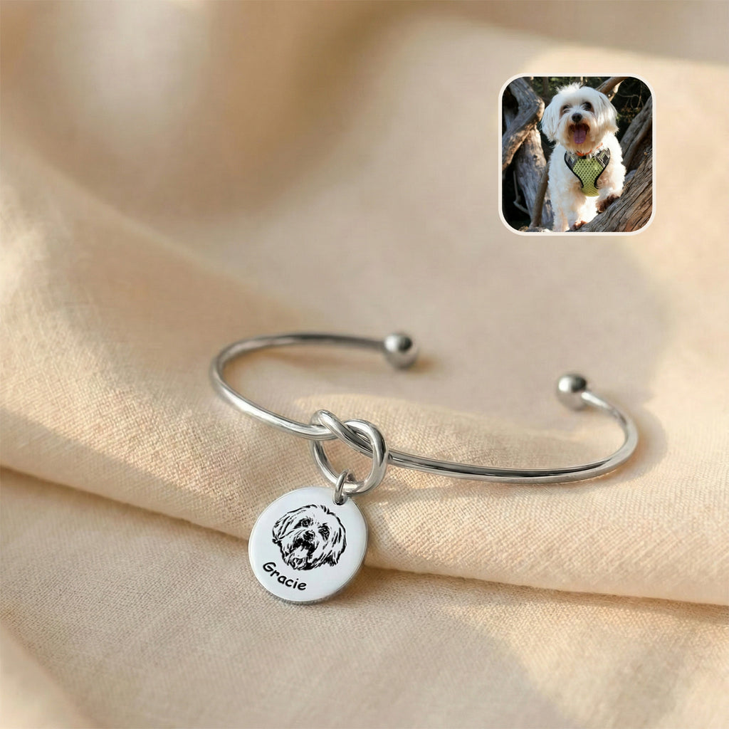 Silver rhodium knot cuff bracelet with engraved Maltese dog portrait disc charm on cream linen, reference photo inset
