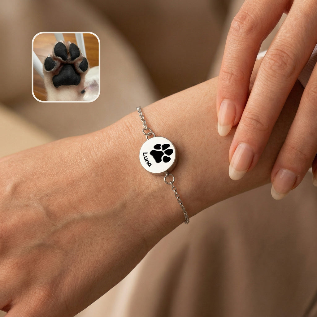 Rhodium silver pet locket bracelet worn on a wrist, the disc engraved with a pet name