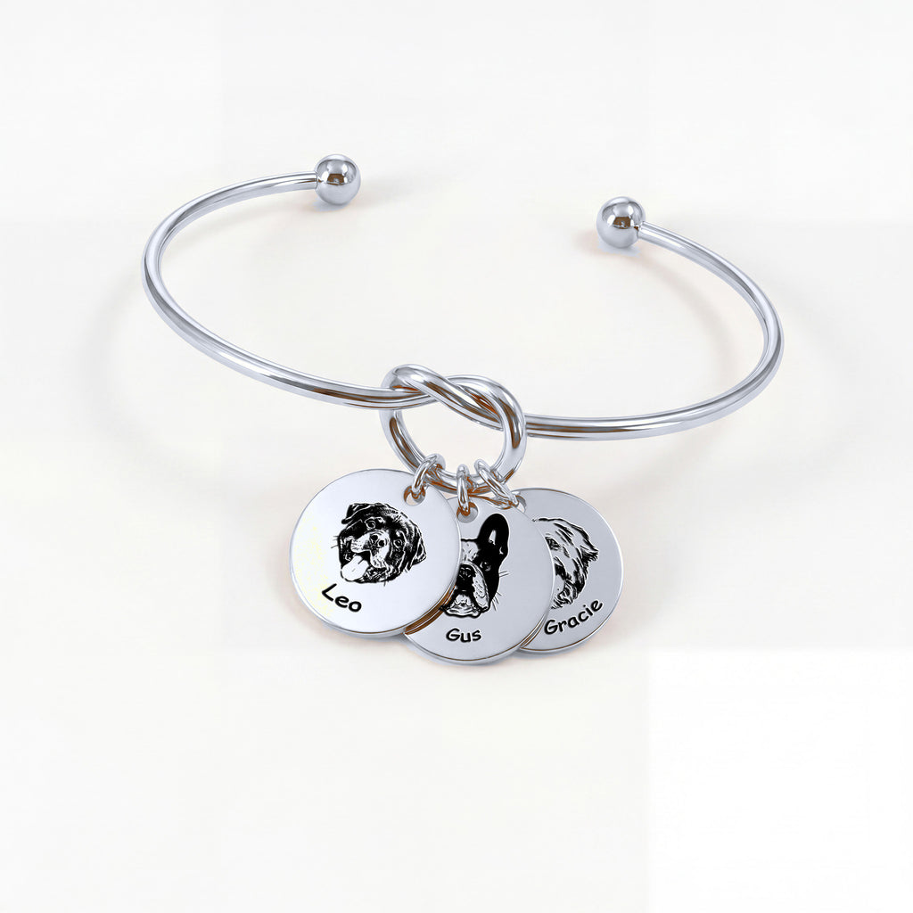 Silver rhodium knot cuff bracelet with three engraved pet portrait disc charms on a white background