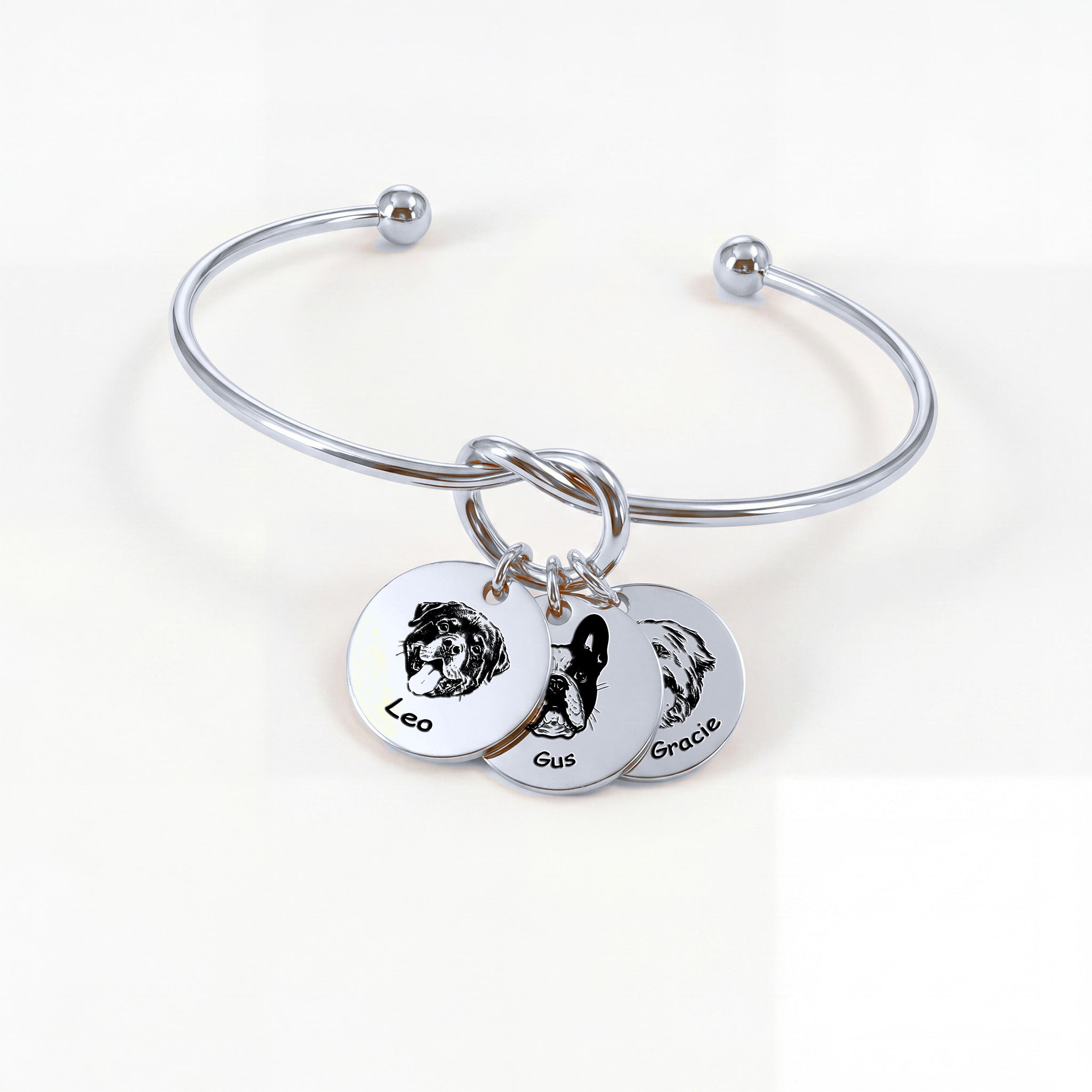 Silver rhodium knot cuff bracelet with three engraved pet portrait disc charms on a white background