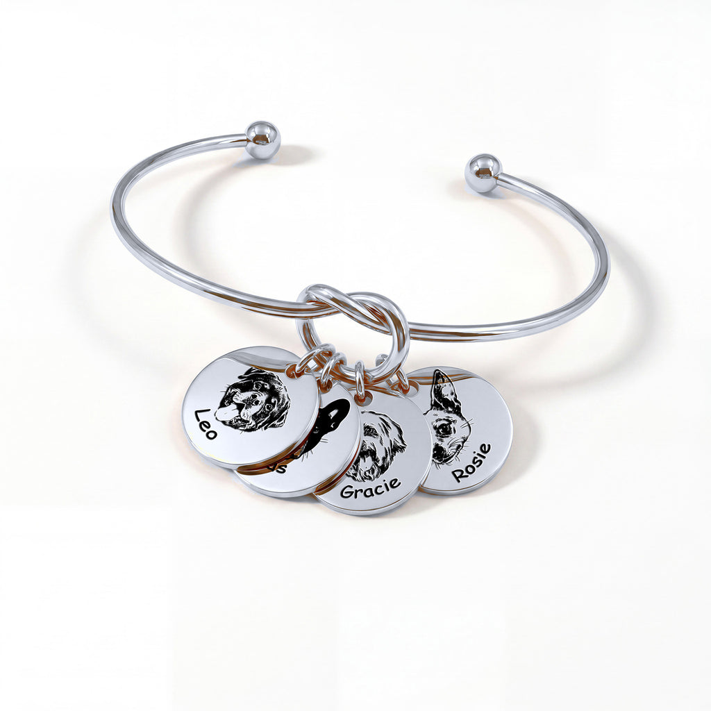 Silver rhodium knot cuff bracelet with four engraved pet portrait disc charms on a white background