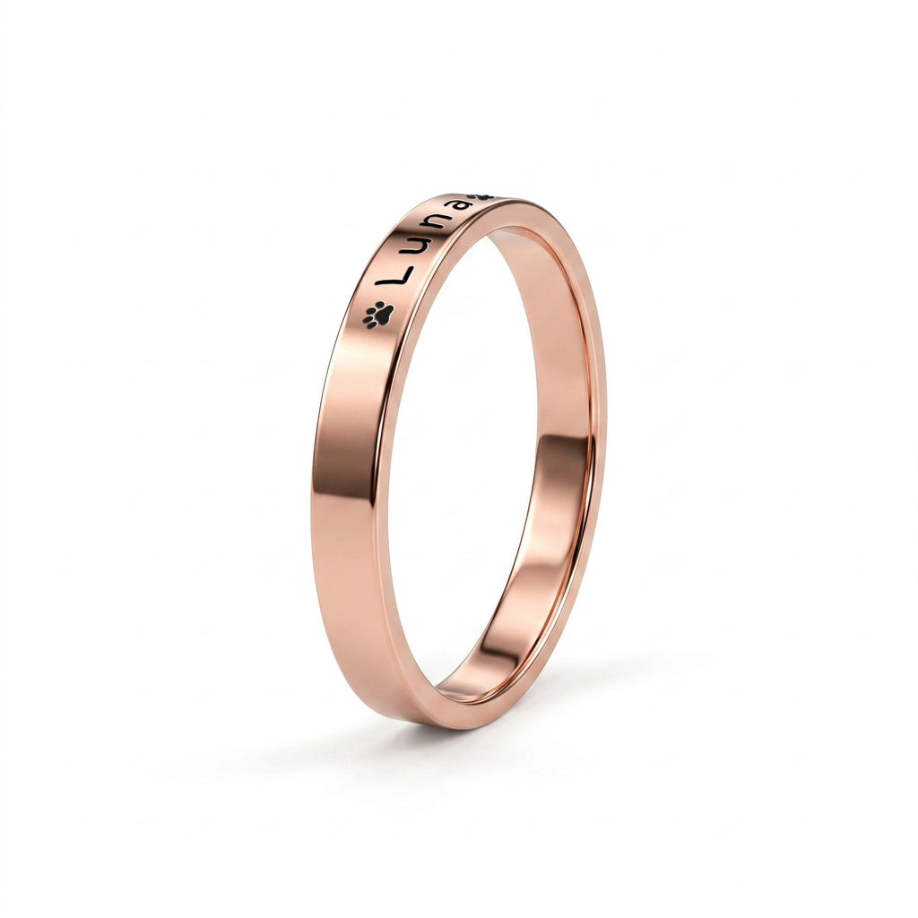 Rose gold pet name band ring on a near-white background with a soft shadow