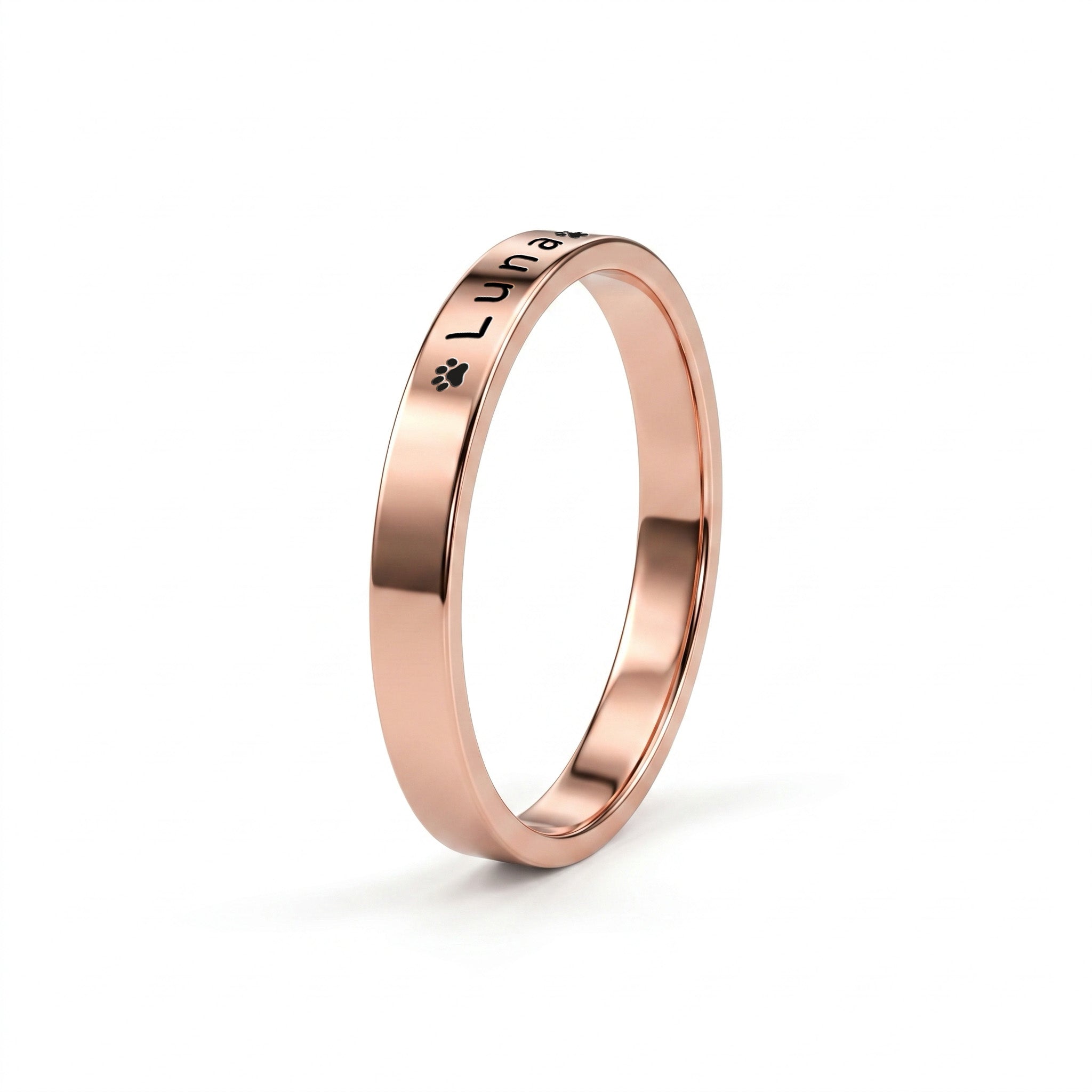 Rose gold pet name band ring on a near-white background with a soft shadow