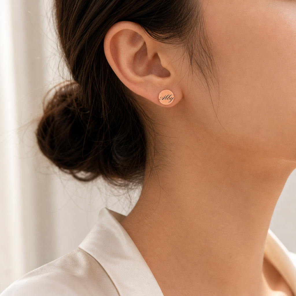 Model wearing a single rose gold pet name stud earring with script name engraving, close ear view