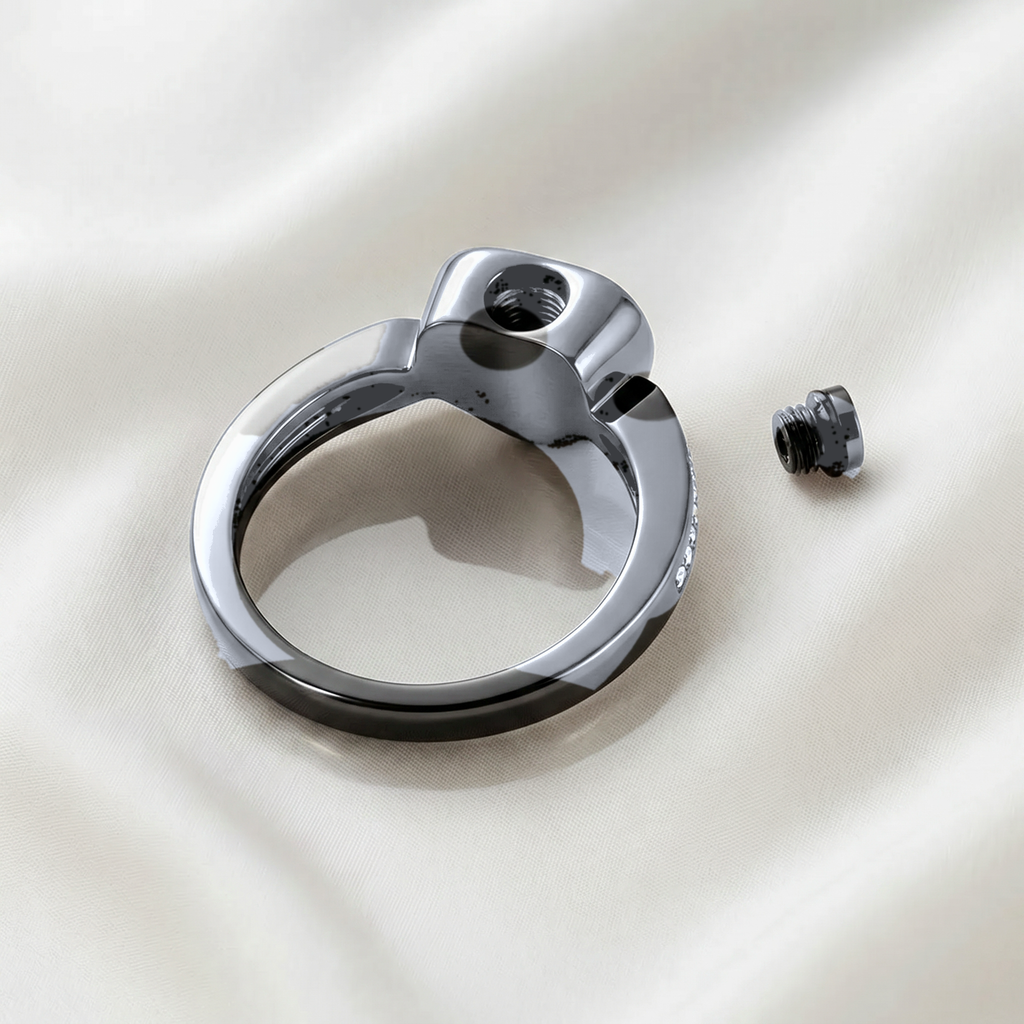 Back of silver heart urn ring showing threaded fill hole with tiny screw removed, revealing the ashes chamber