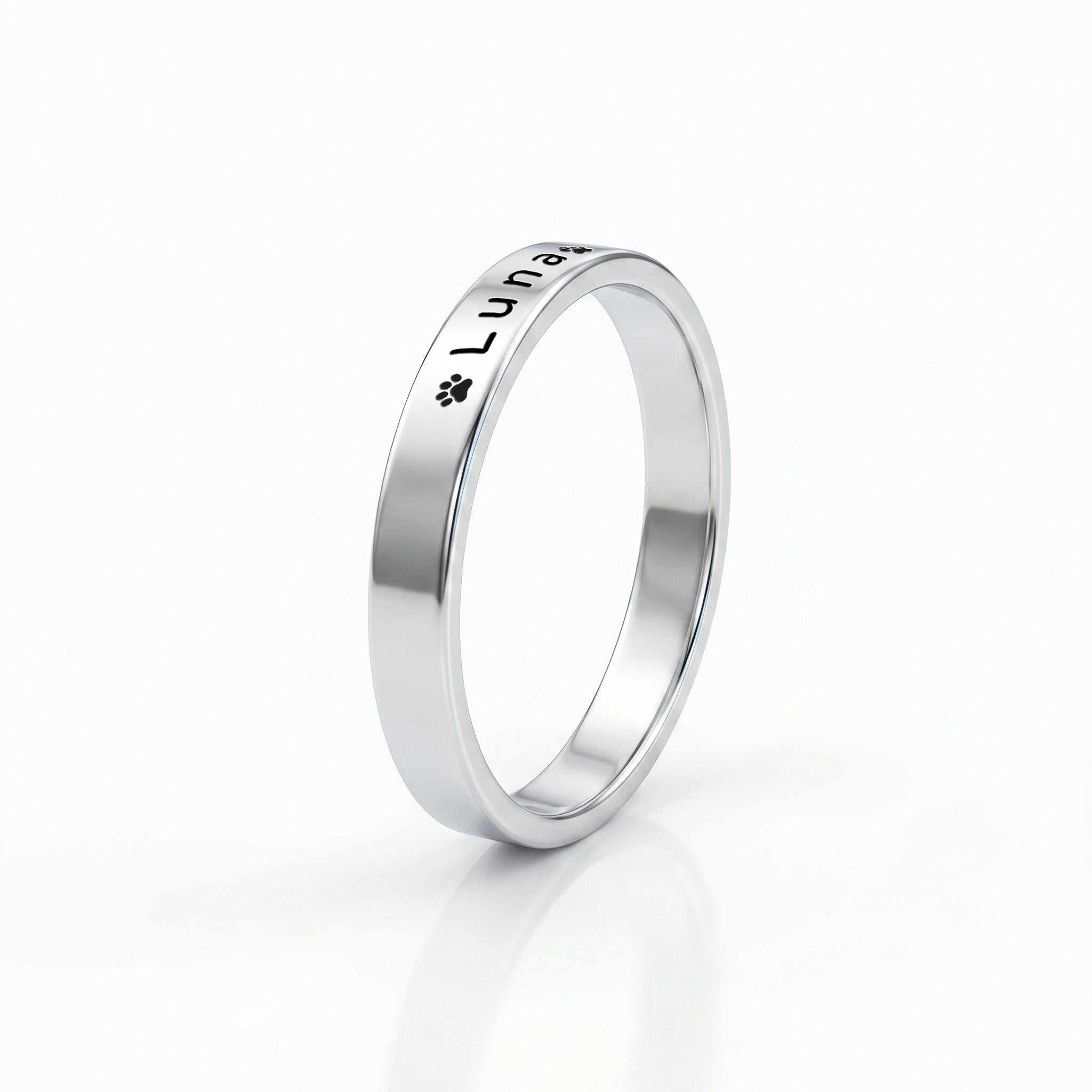 Silver pet name band ring on a near-white background with a soft shadow