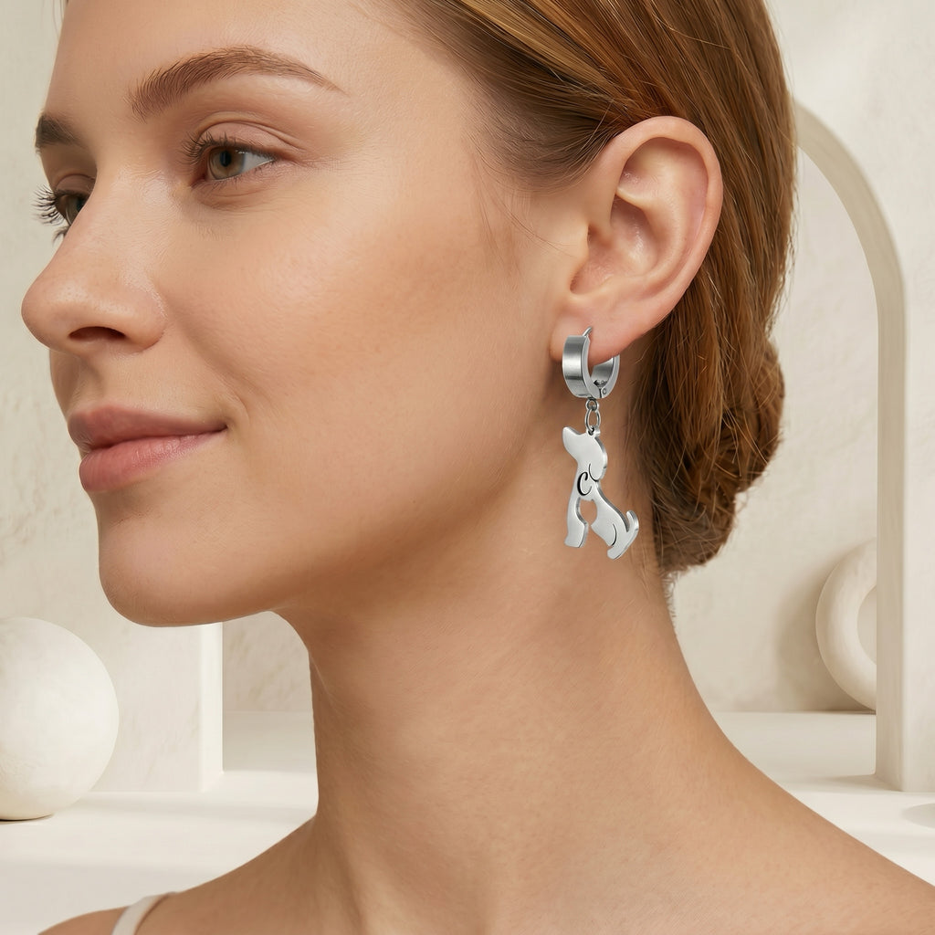 Model wearing a single silver dog-silhouette name earring