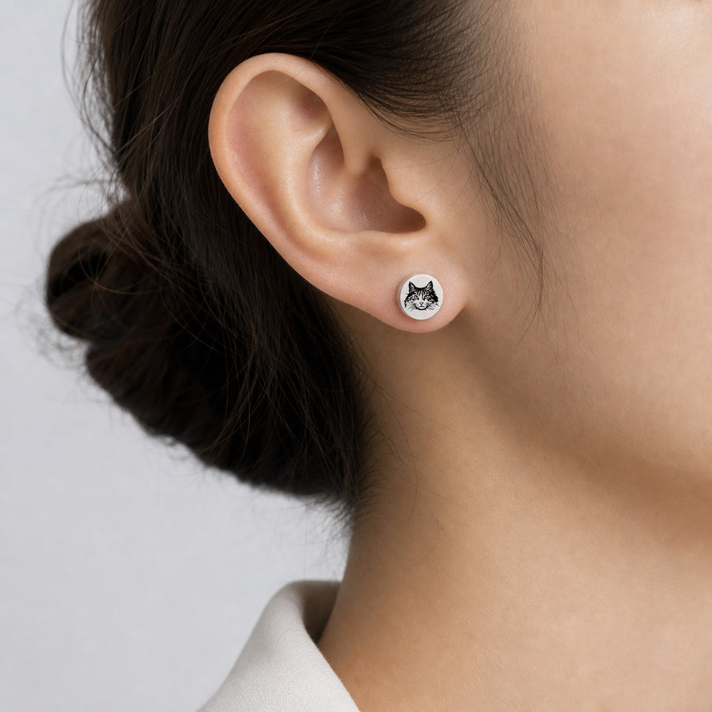 Model wearing a single silver pet portrait stud earring with hand-drawn pet face engraving