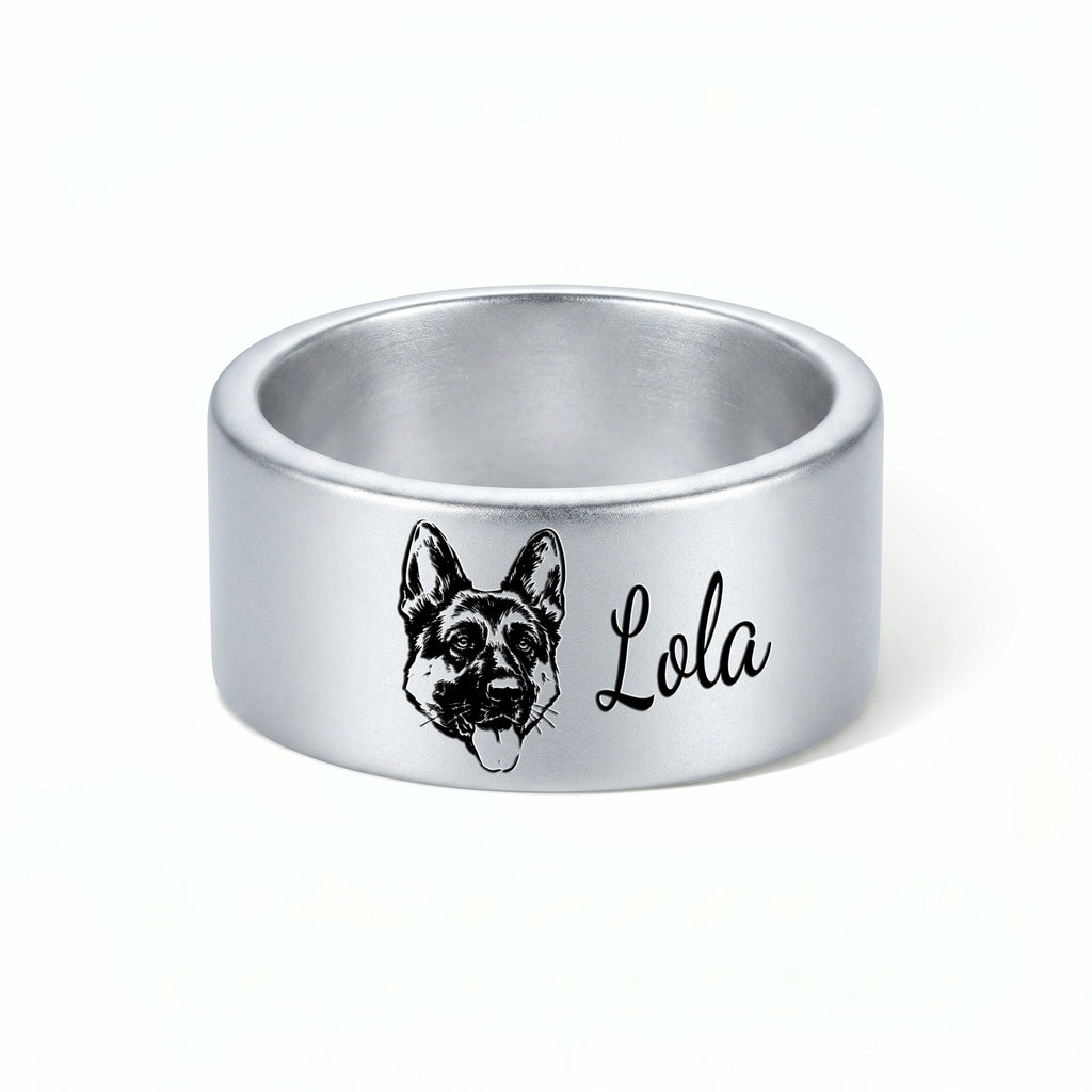 Single silver wide band pet ring on a near-white background, engraved hand-drawn portrait and script name